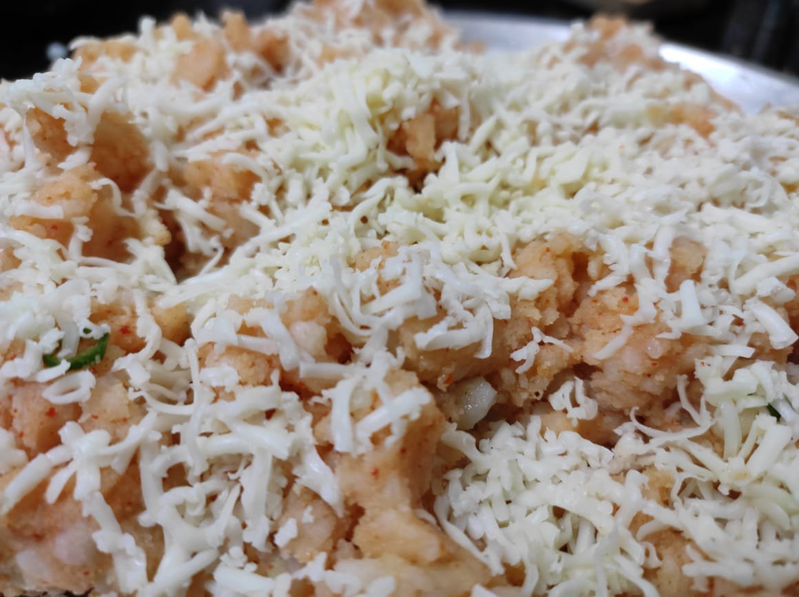 Grated cheese added to poha batter