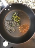 adding spices in a pan