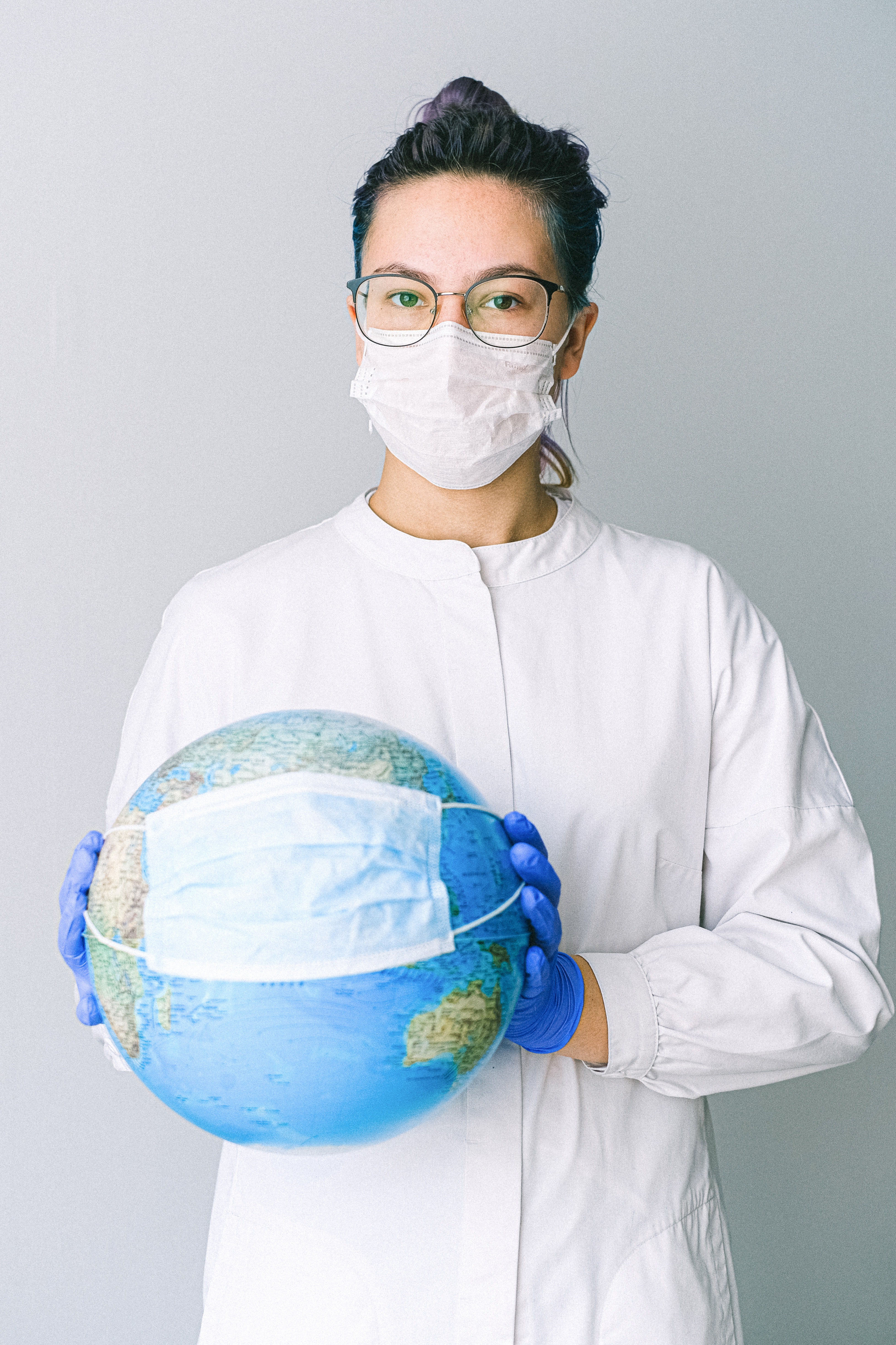 a doctor holding a globe with mask on it