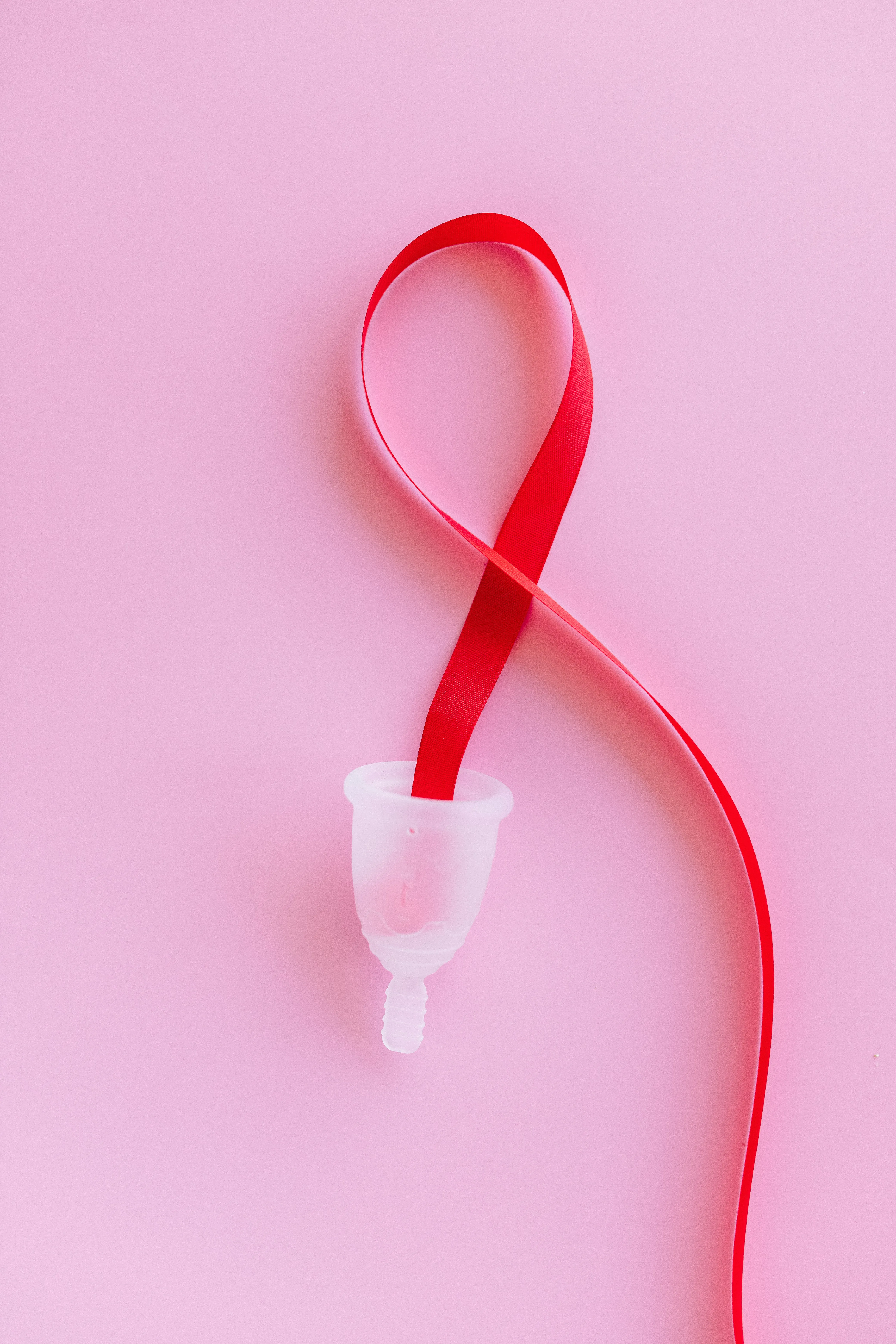 a menstrual cup and a ribbon