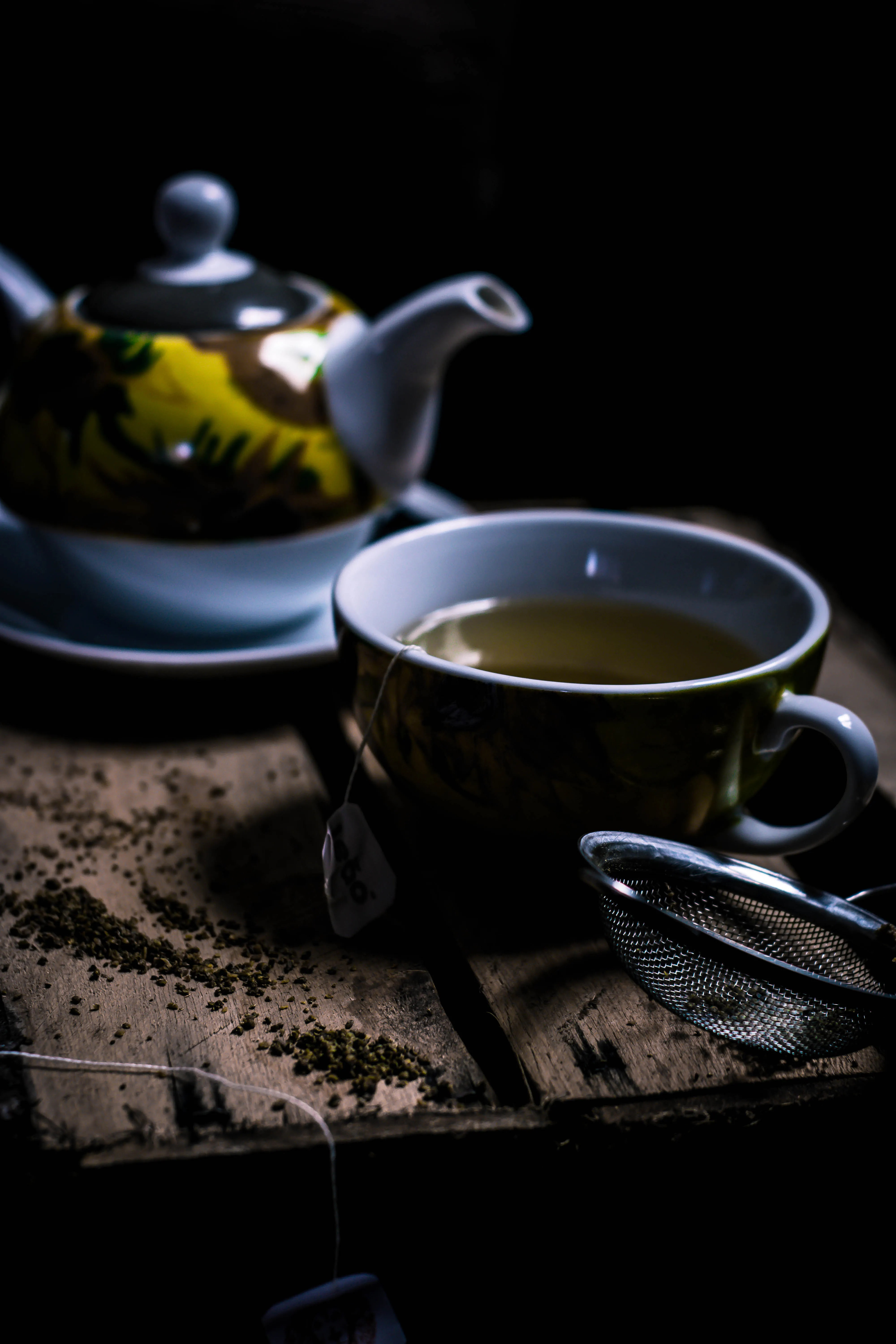 a kettle and cup with green tea