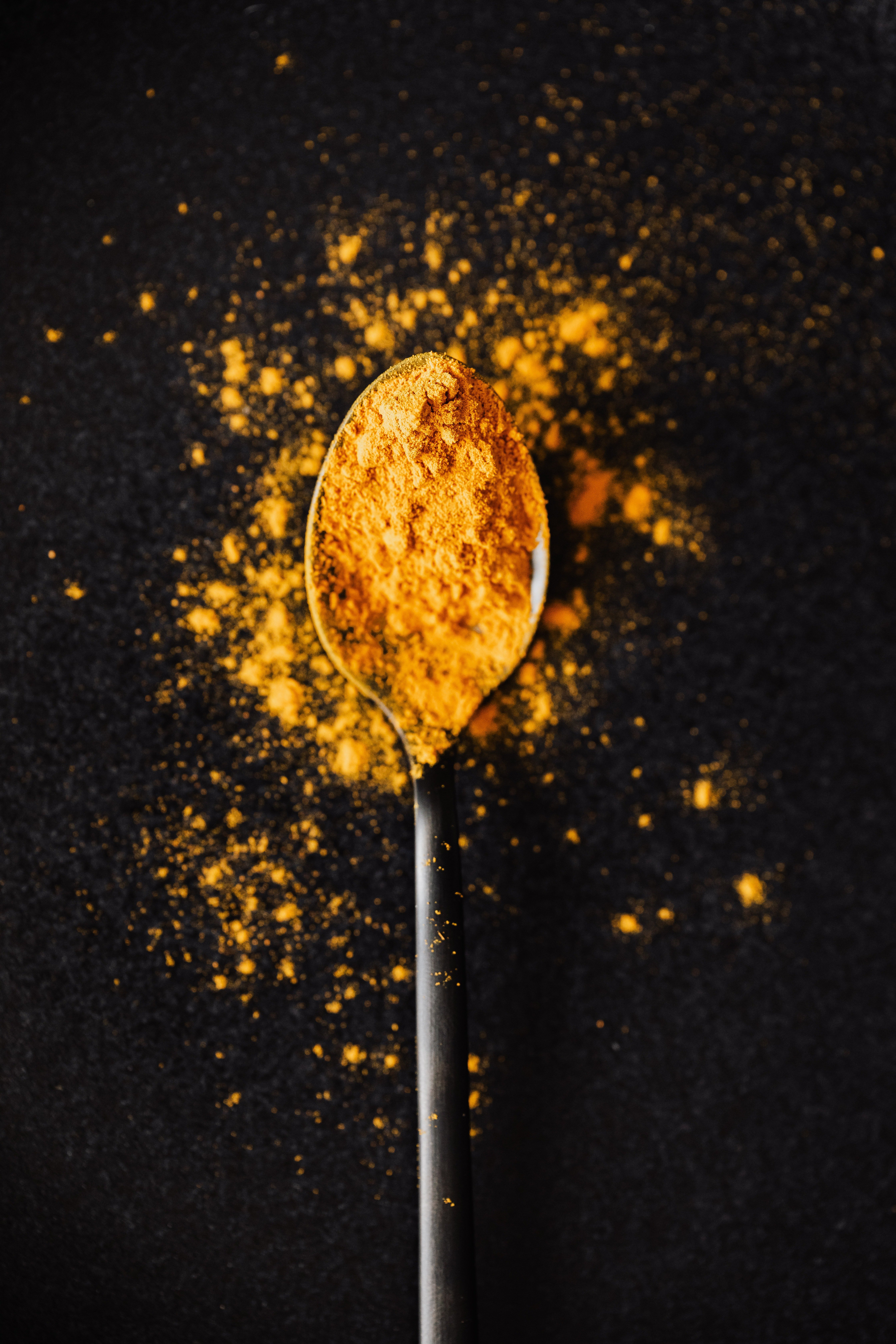 Image of turmeric powder in a spoon