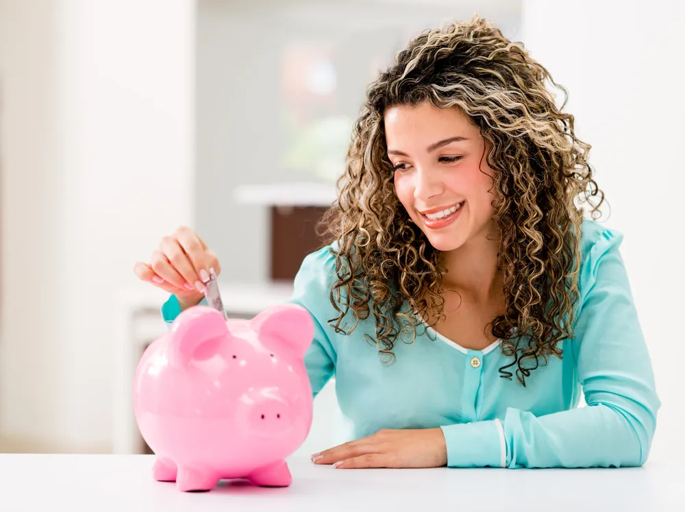 a lady saving money in a piggy bank