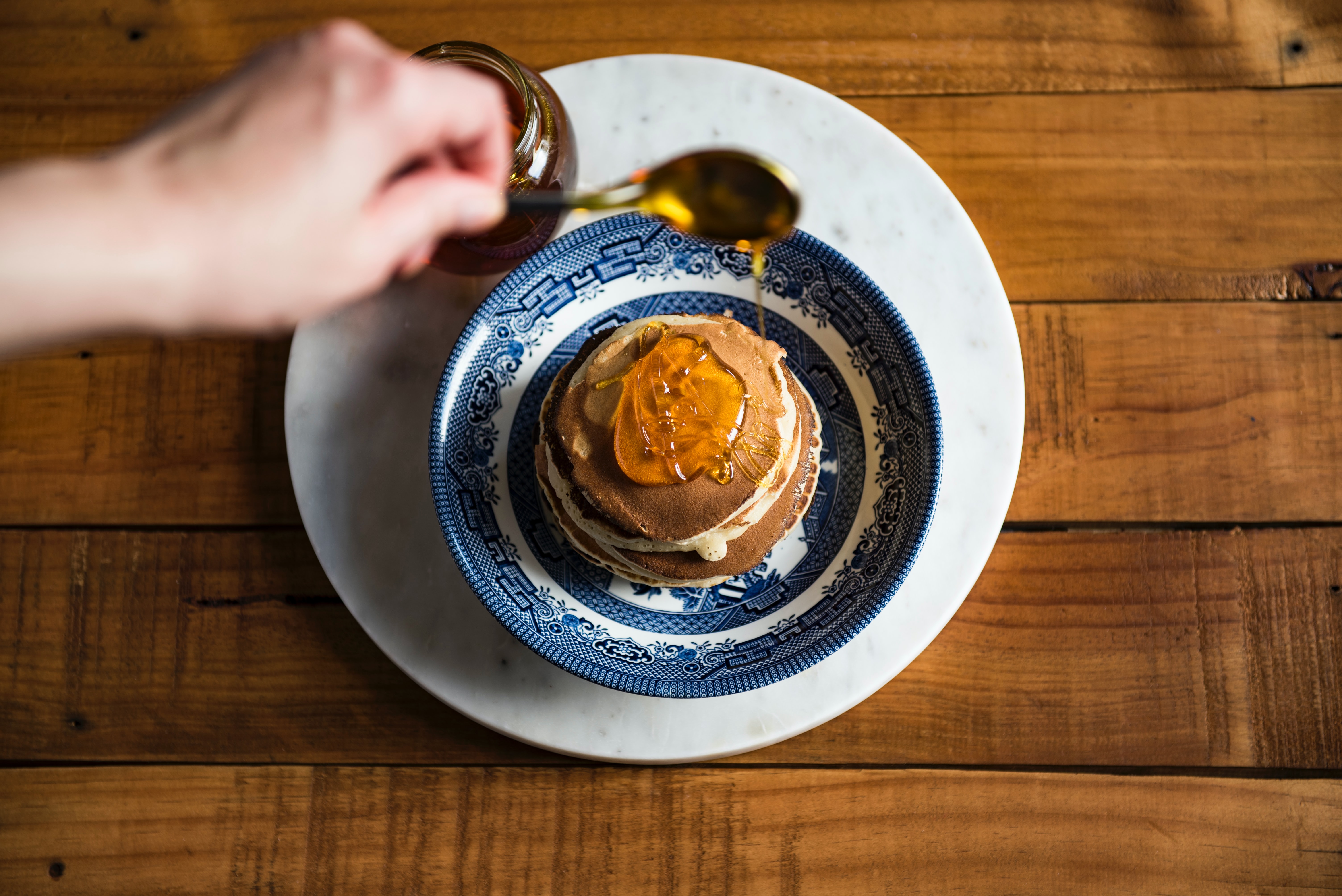 pancakes on a plate with honey and maple syrup