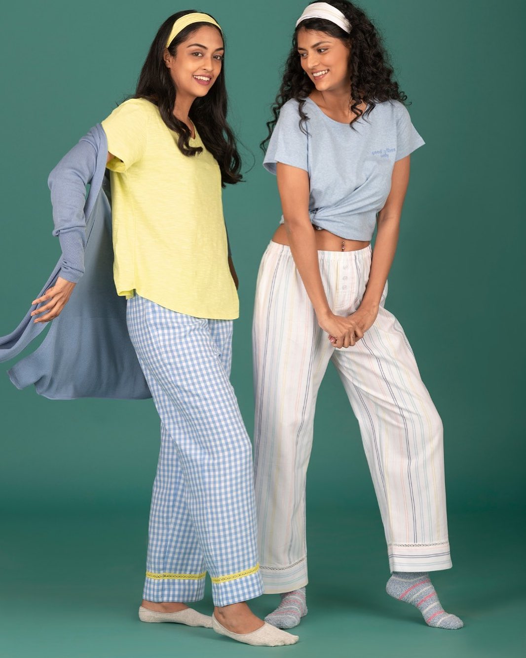 Two girls wearing nightwear and smiling