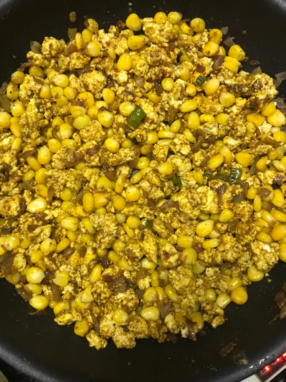 cooking paneer and corn together with spices