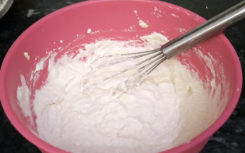 Curd in a bowl with a whisk