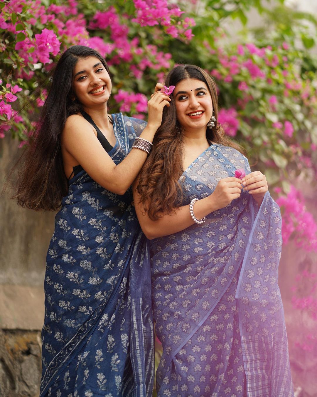 2 women wearing blue sarees