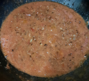 tomato puree in hot oil with onions