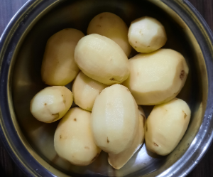 A container with peeled potatoes 