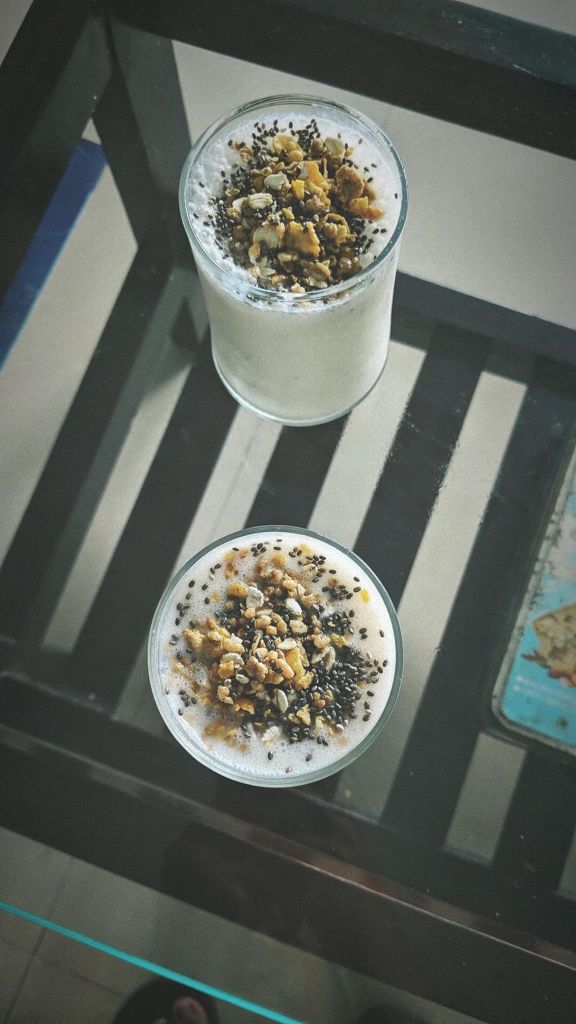 Delicious banana lassi topped with dry fruits