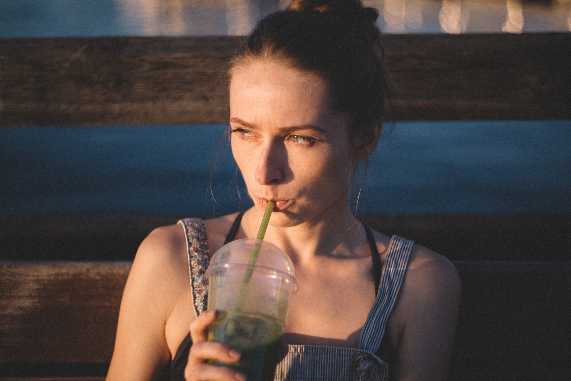 lady drinking a green drink
