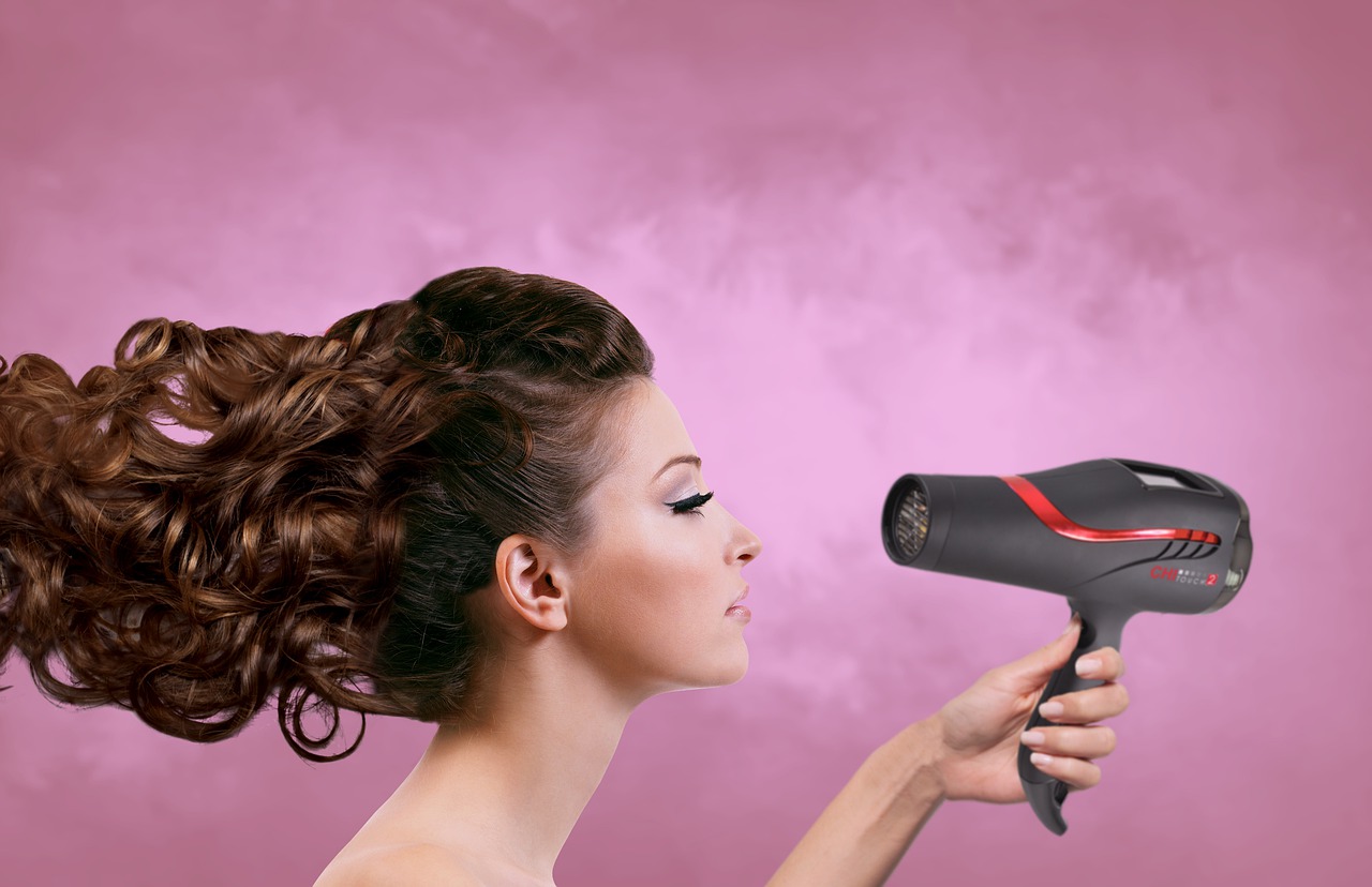 a lady using hair dryer