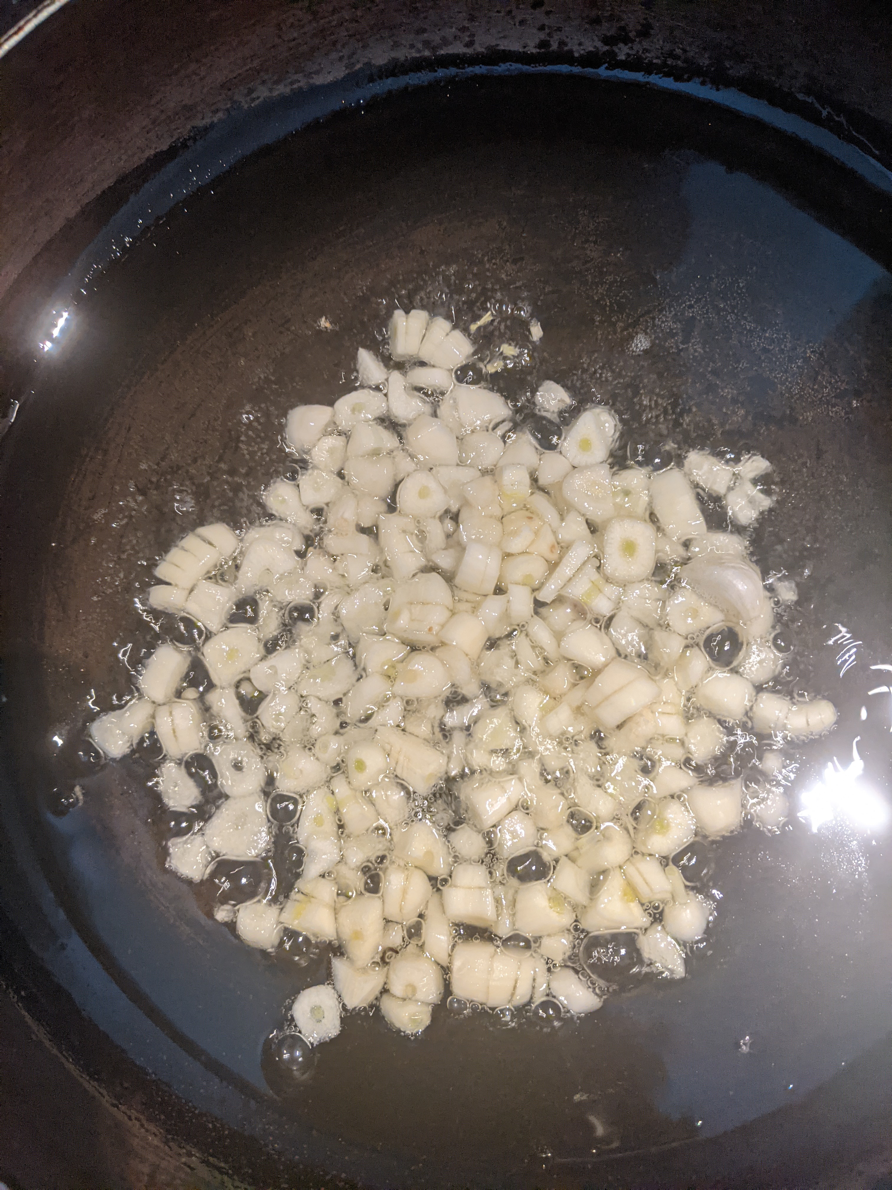 garlic sautéing in oil in a pan