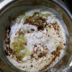 grated onions, cucumber and spices in curd