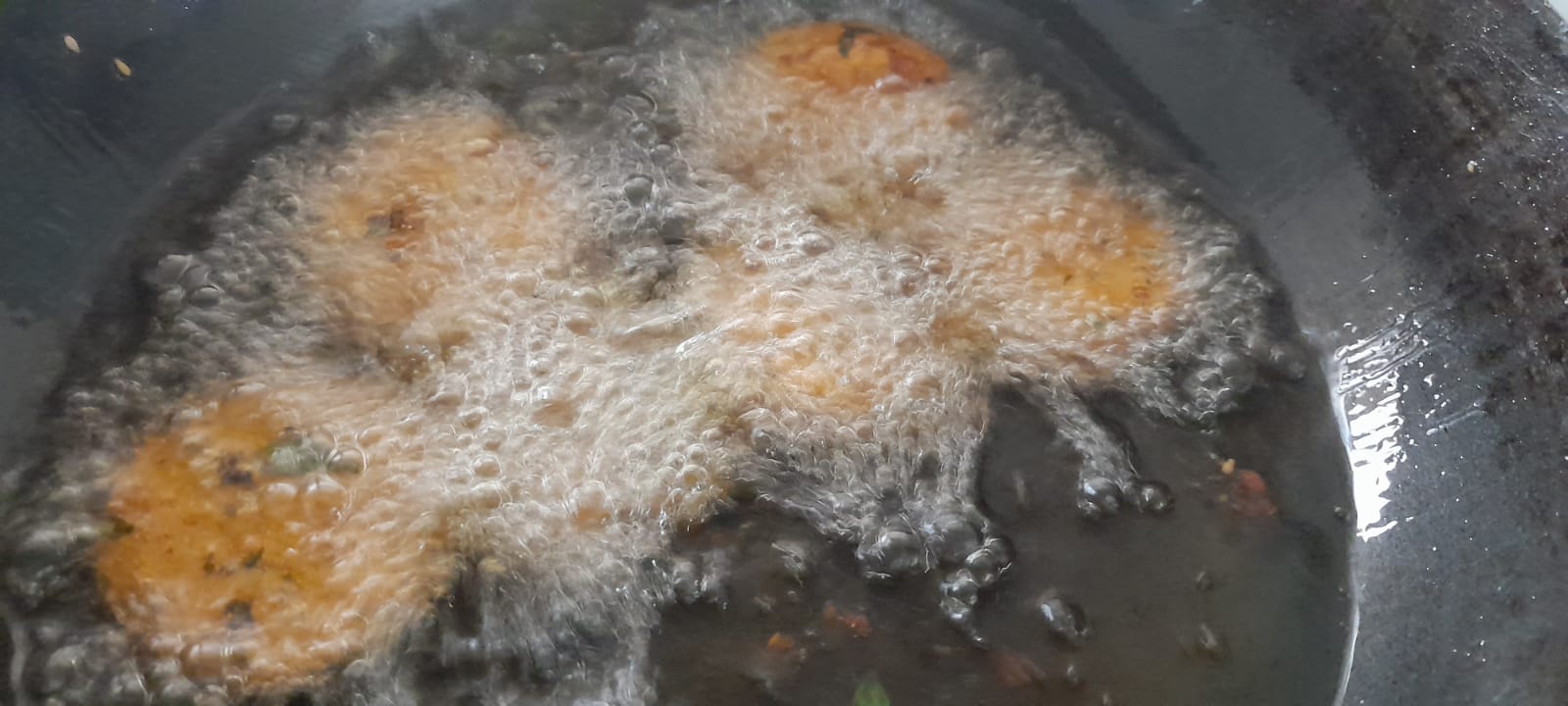 Bajra Vada frying in a pan