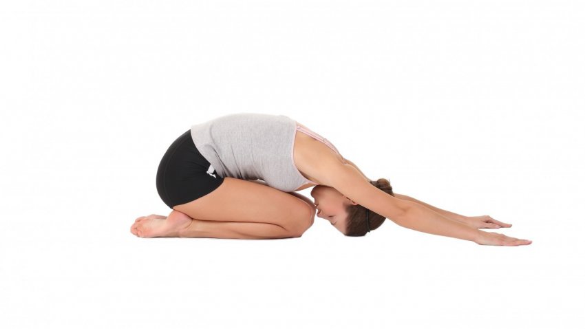 A female in Yoga position Balasana - Child's Pose