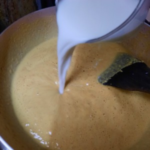 Adding milk to besan halwa
